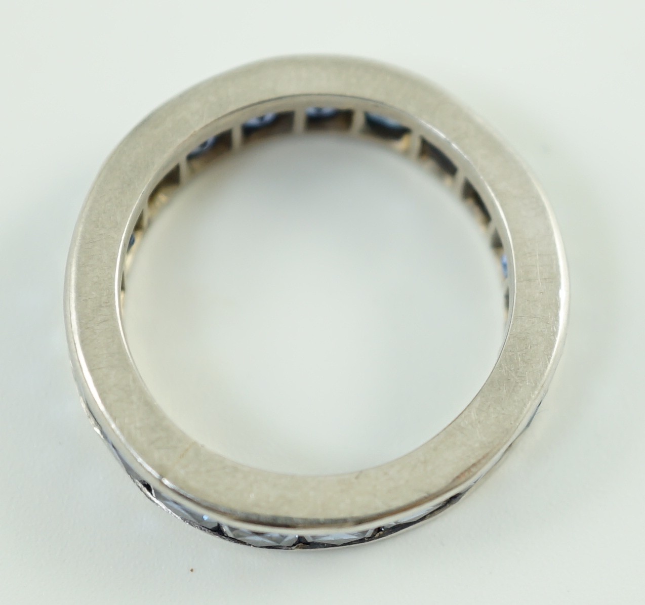 A platinum? and square cut sapphire set full eternity ring